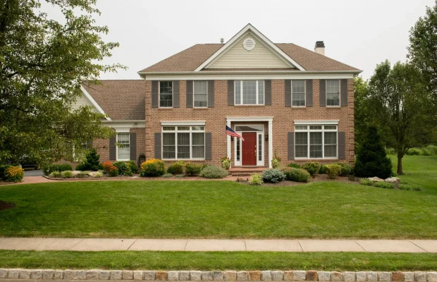 Summer-Front-Yard-with-Shrubs-Mulch-Garden-Beds-Paver-Path-Full-View-Landscape