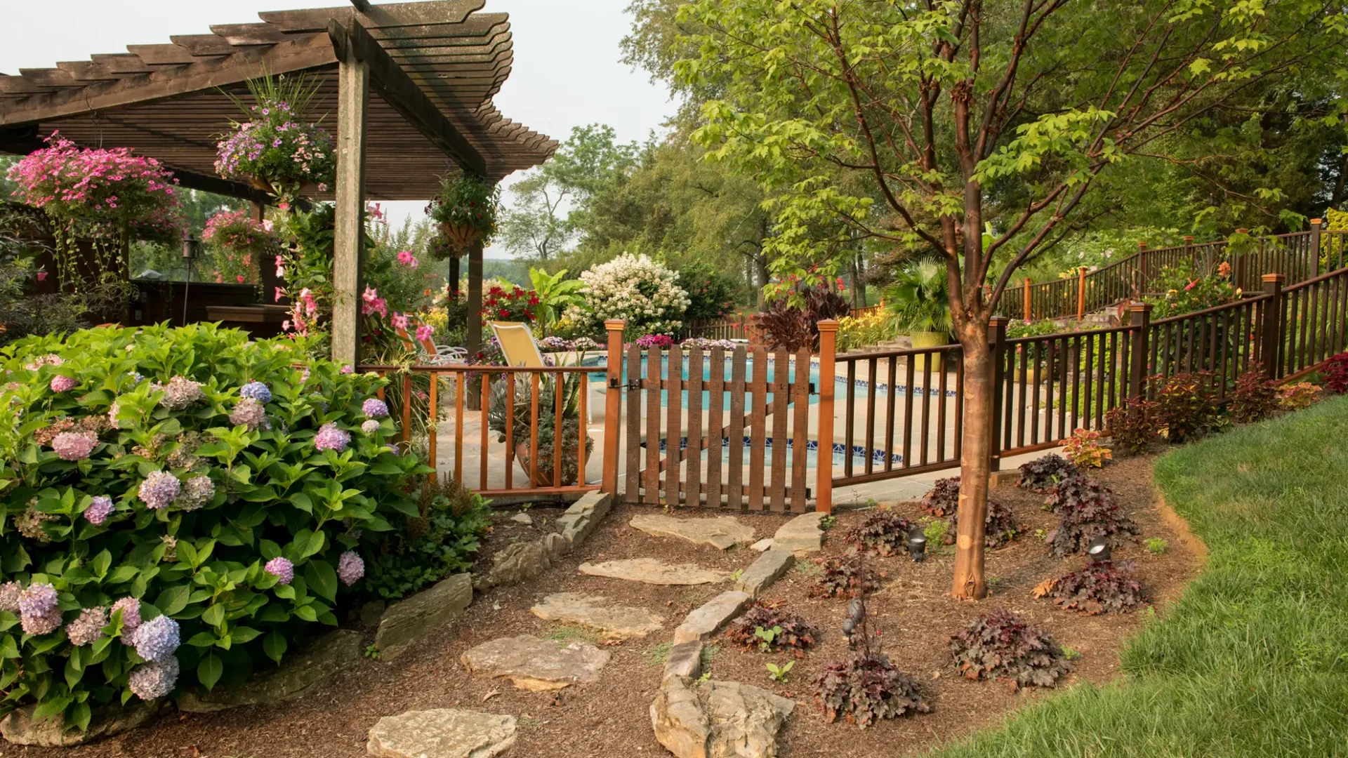 Summer-Landscape-Natural-Stone-Path-Pool-Garden-Beds-Hydrangeas-Hanging-Baskets